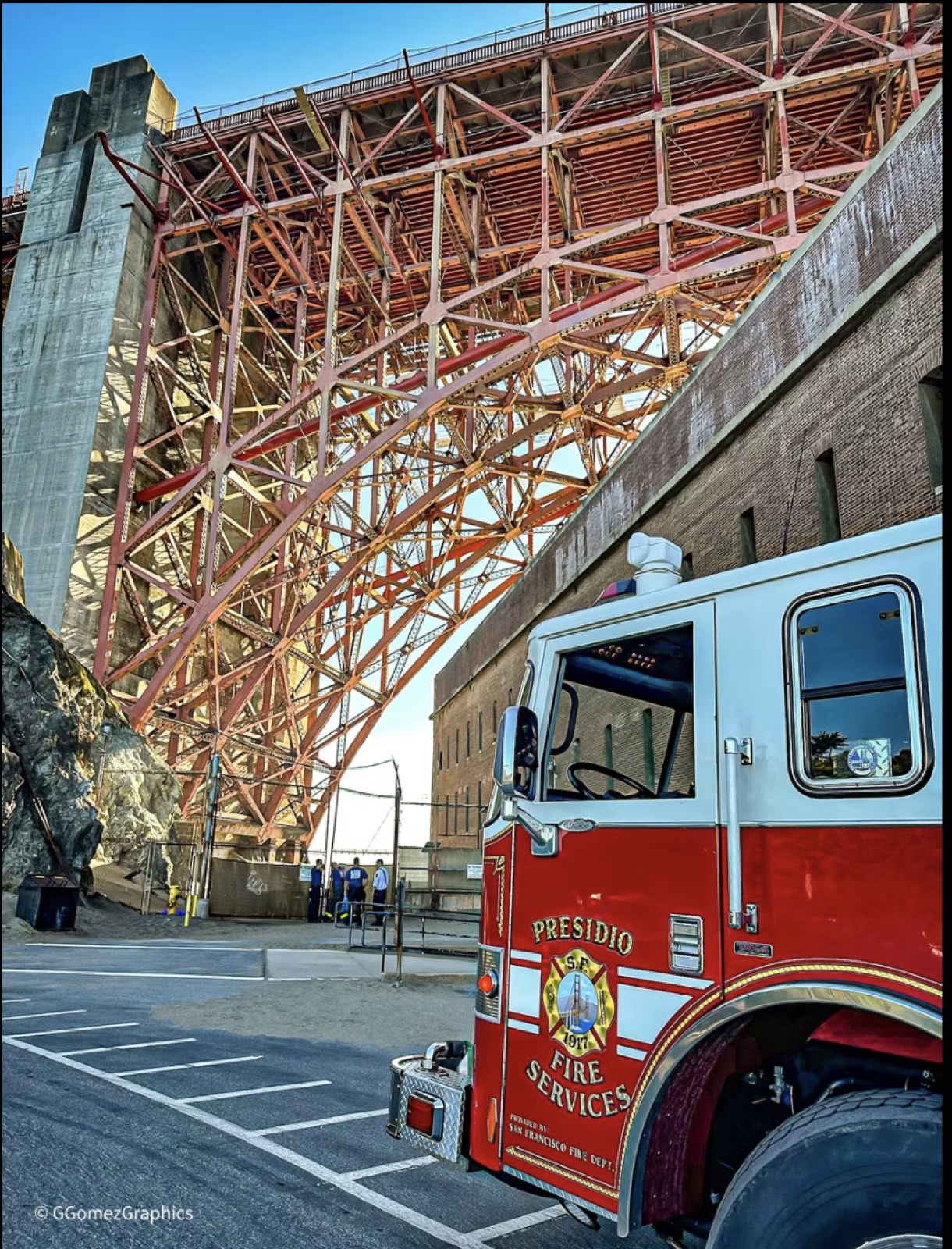 A Presidio fire engine parked in the steel shadow of the Golden Gate Bridge approach