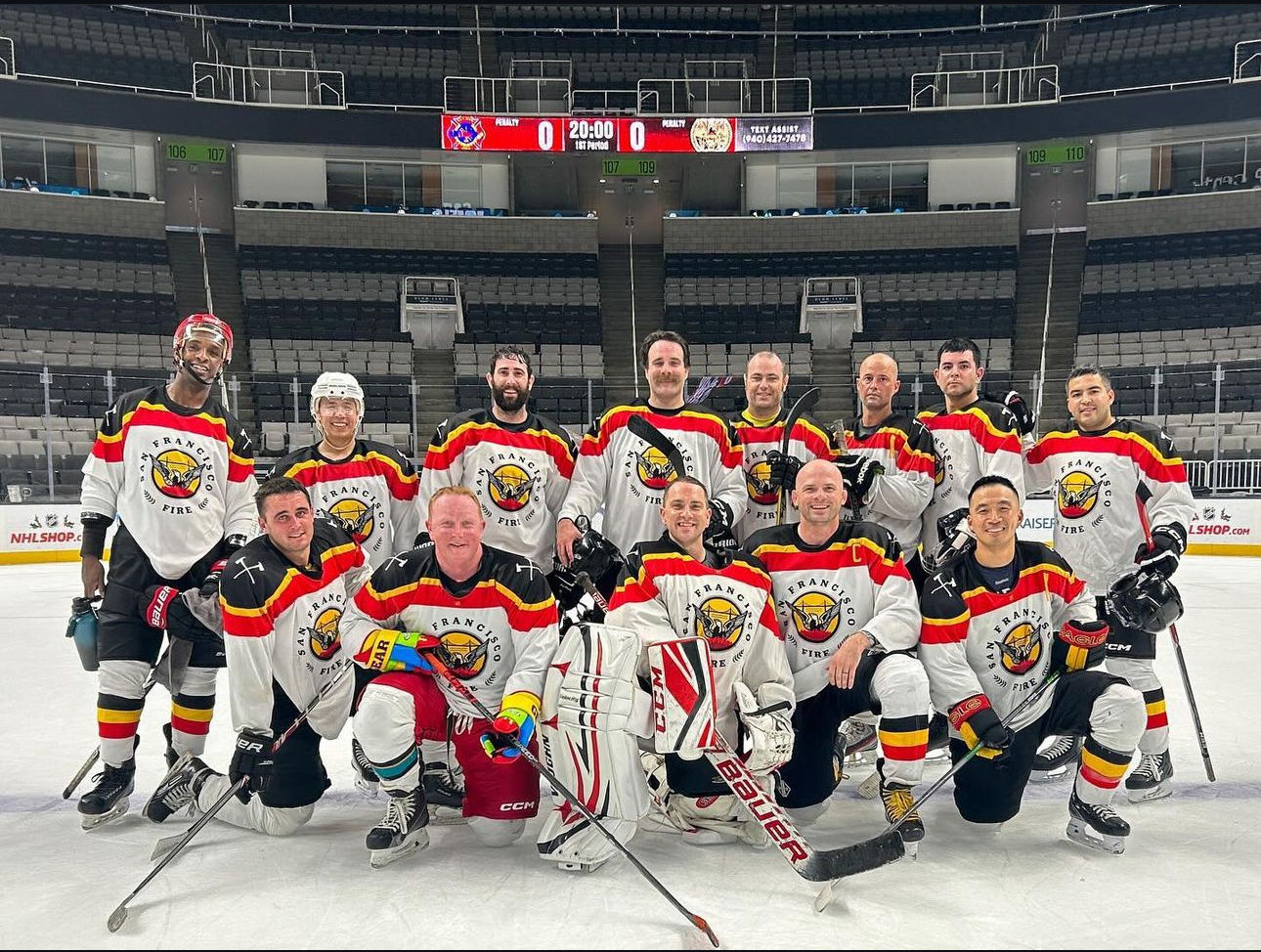 The hockey club lined up on the ice in an empty arena